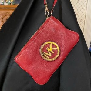 Small red Micheal Kors wristlet with zipper
